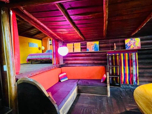 a room with a couch and a bed in a room at El Sol Monteverde in Monteverde Costa Rica