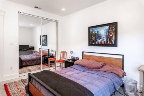 a bedroom with a large bed and a mirror at HUGE Open Concept Living in Best Location in San Francisco