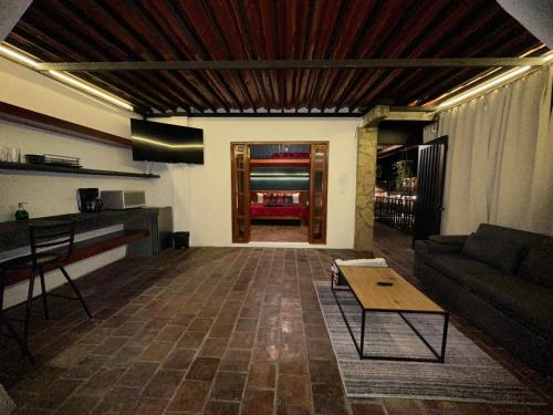 a living room with a couch and a table at Hotel Muk´ul Na in San Cristóbal de Las Casas