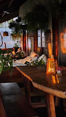 a room with a wooden table and a bed at Casa Cactus Praia in Macau