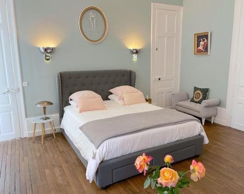 ein Schlafzimmer mit einem großen Bett mit rosa Kissen in der Unterkunft Villa Joséphine in Brienne-le-Château