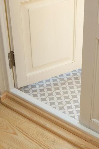 a white door with a tile floor in front of it at Lemon Apartments in Istanbul