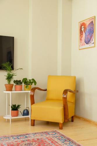a yellow chair sitting in a living room at Lemon Apartments in Istanbul