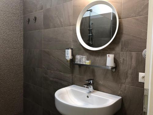 a bathroom with a sink and a mirror at Vila Navona in Saturn