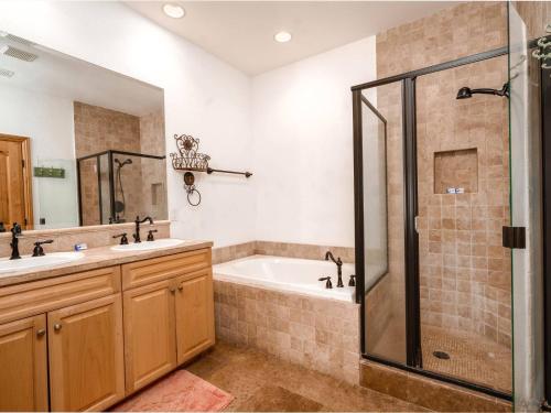 a bathroom with a tub and a sink and a shower at El Dorado Ranch Vacation Rental Condo 21-1 in San Felipe