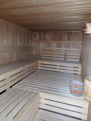 a sauna with wooden flooring and a tub in it at Bocksberg-Lodge in Goslar