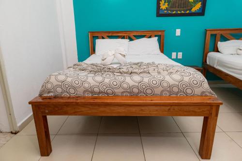 a bed with a brown comforter with a bow on it at Hotel Las Palmas en Laurel in Cancún