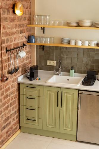 a kitchen with green cabinets and a sink at Lemon Apartments in Istanbul