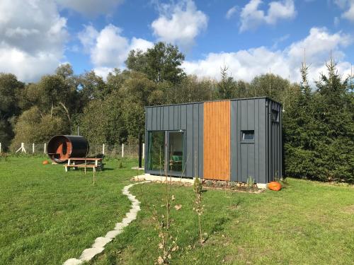 a tiny house in the middle of a field at TinyHouse & Garden in Geceľ