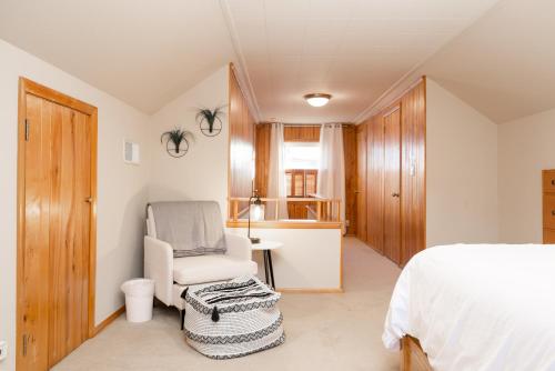 a bedroom with a bed and a chair and a desk at Beard Avenue Bungalow! in Minneapolis