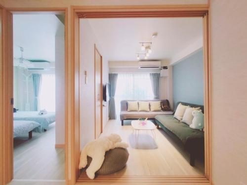 a mirror reflecting a living room with a dog laying on the floor at SY Mansion - Vacation STAY 15495 in Saitama