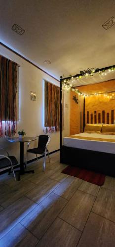 a bedroom with a bed and a desk and a table at PH BOUTIQUE HOTEL Girardot in Girardot