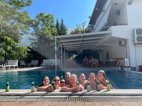 a group of women in a swimming pool with beer at Hotel Aroma in Përmet