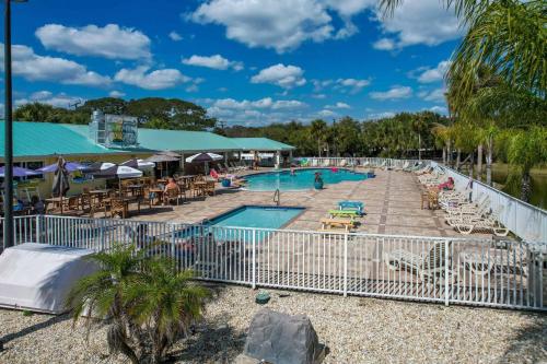 a pool at a resort with tables and chairs at Ocean Grove RV Resort St Augustine in Saint Augustine