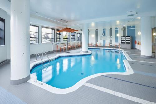 a large swimming pool in a hotel lobby at Holiday Inn & Suites Ottawa Kanata, an IHG Hotel in Ottawa