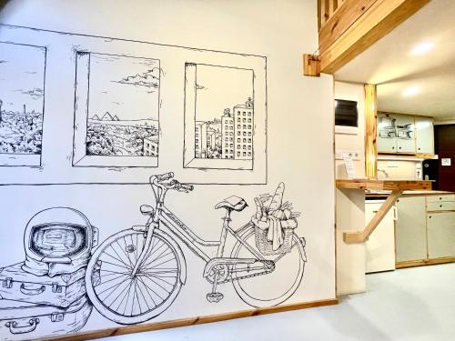 a drawing of a bike on a wall in a kitchen at Lavender Circus Hand Drawn Apartments in Budapest