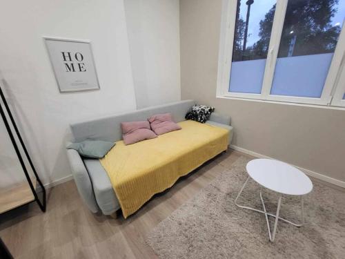 a bedroom with a bed with two pillows on it at Appartement canada 1 in Valenciennes