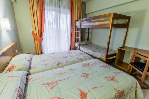 a bedroom with a bed and a bunk bed at Hotel Alhama in Cintruénigo