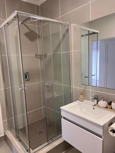 bagno con doccia e lavandino di Ultra Modern Apartment - Self Catering a Ballito