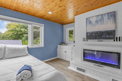 a bedroom with a large flat screen tv and a bed at Indoor Pool Near Grand Haven & Lake Michigan Beach in Spring Lake