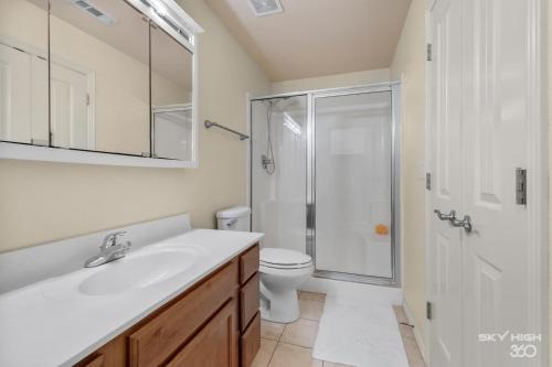 a bathroom with a sink and a shower and a toilet at The Alberta Cottage in Fayetteville