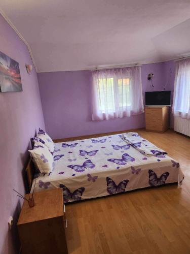 a bedroom with a bed with butterflies on it at Guest House Iveta in Sofia