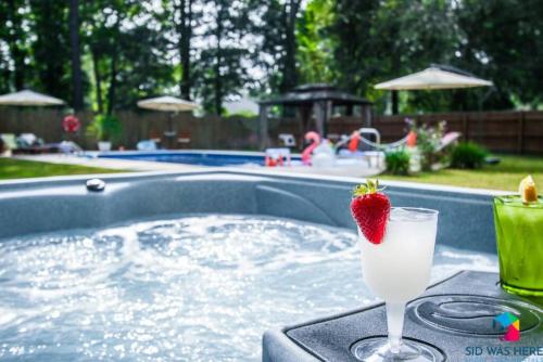 a strawberry in a drink on a tray in a pool at Savannah 5BR Pool, Jacuzzi, Firepit, Sports, Games in Savannah
