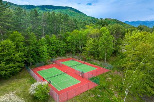 an overhead view of two tennis courts in the woods at Inviting Bartlett Condo 1 Mi to Attitash Mountain in Bartlett