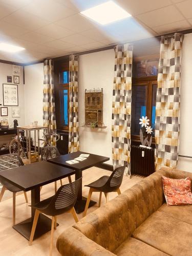 un salon avec un canapé, une table et des chaises dans l'établissement LA MARIEFACTURE - Comme à la Bicyclette, à La Petite-Pierre