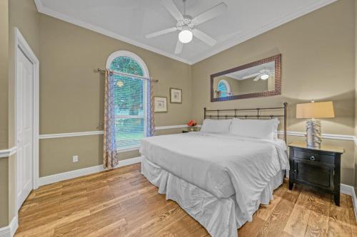 a bedroom with a bed and a ceiling fan at Destiny Casa - PRIVATE HEATED POOL and 6 SEATER GOLF CART in Destin