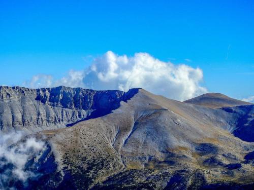 a view of a mountain with clouds in the sky at Olympus Mytikas Apartment in Litochoro