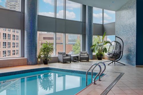 a swimming pool in a building with windows at JW Marriott Grand Rapids in Grand Rapids