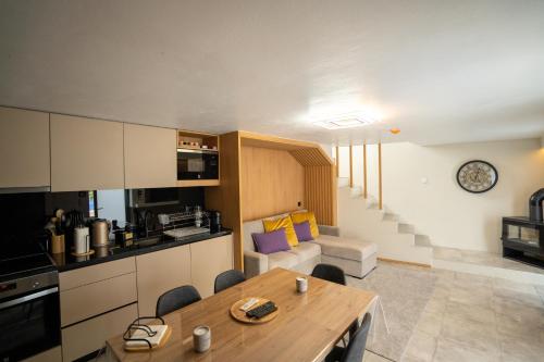 a kitchen and living room with a wooden table in a room at Casa Douro River in Frende