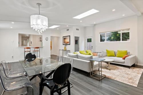 a living room with a glass table and a couch at Lovely North Hollywood House Near Universal in North Hollywood
