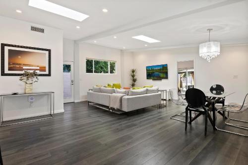 a living room with a couch and a table at Lovely North Hollywood House Near Universal in North Hollywood