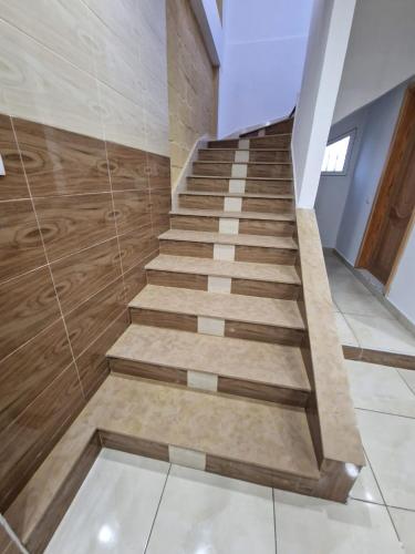 a staircase in a house with wooden floors at Villa Fares Assilah 1 in Asilah