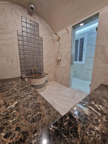 a large bathroom with a shower and a sink at Villa Fares Assilah 1 in Asilah