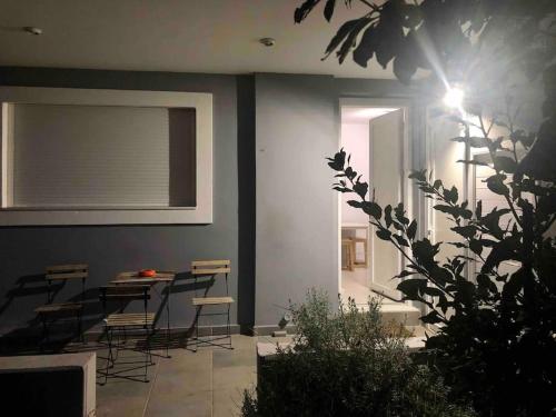 a room with chairs and a table and a window at Maria’s apartments in Sparti
