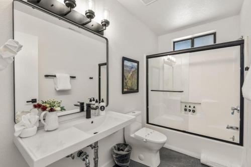 a white bathroom with a sink and a toilet at Birch Ave Beauty by Dwell in Flagstaff