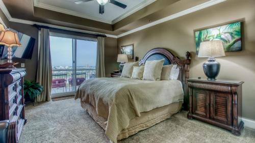a bedroom with a bed and a large window at Harbor Landing 701B - 3BR Luxury condo with Gulf and Destin Harbor Views in Destin