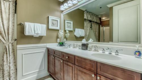 a bathroom with a sink and a large mirror at Harbor Landing 701B - 3BR Luxury condo with Gulf and Destin Harbor Views in Destin