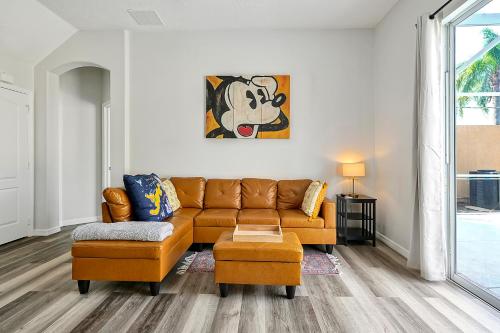 a living room with a couch and a chair at 4BR Villa near Disney & Universal in Orlando, FL in Davenport