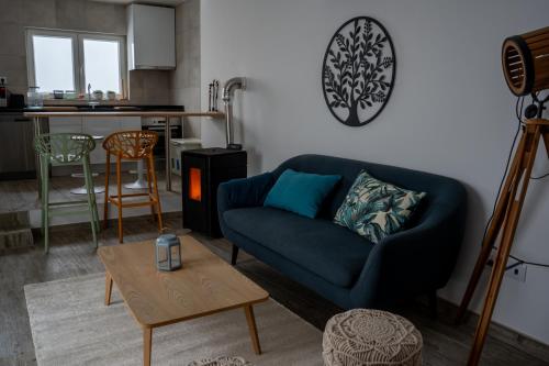 a living room with a blue couch and a table at Tavira Nomad Guesthouse in Tavira