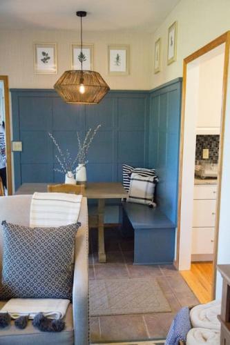 a dining room with a table and a blue wall at Wingate - Meridian, Cozy Acreage in the heart of the city in Meridian