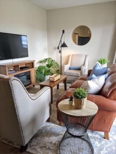 a living room with couches and a tv at Wingate - Meridian, Cozy Acreage in the heart of the city in Meridian