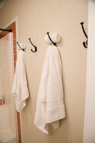 two towels are hanging on a wall in a bathroom at Wingate - Meridian, Cozy Acreage in the heart of the city in Meridian