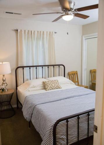 a bedroom with a bed with a ceiling fan at Wingate - Meridian, Cozy Acreage in the heart of the city in Meridian