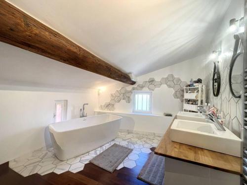 a bathroom with a large tub and a sink at Charme & cosy à Vourles in Vourles