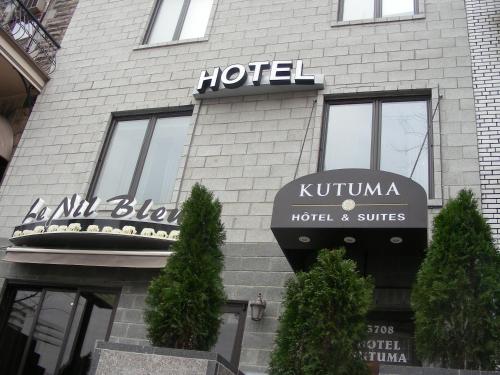 a brick building with a sign on the front of it at Hotel Kutuma in Montreal