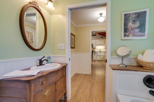 a bathroom with a sink and a mirror at Roscommon Cottage - Walk to Higgins Lake! in Roscommon